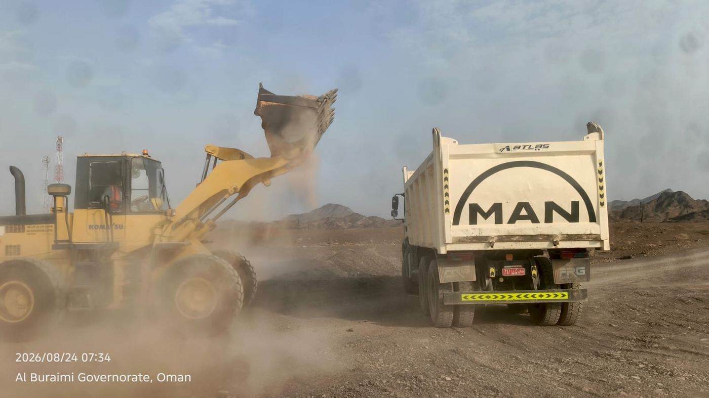 Wheel loader filling a tipper truck with aggregate in Al Buraimi